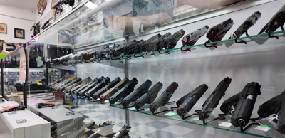 Guns displayed in the counter at local pawn shop.