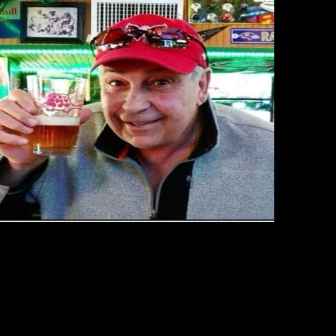 Steve Pappas holding up a beer