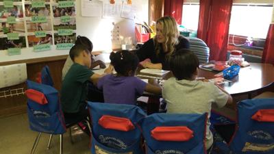 Four students participate in a reading exercise led by their teacher at Fairview Elementary School.