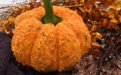 small pumpkin with fall colors in the background