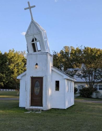 The chapel at Jusst Sooup Ministry Church with a crooked steeple. The base of the church is in good condition. 