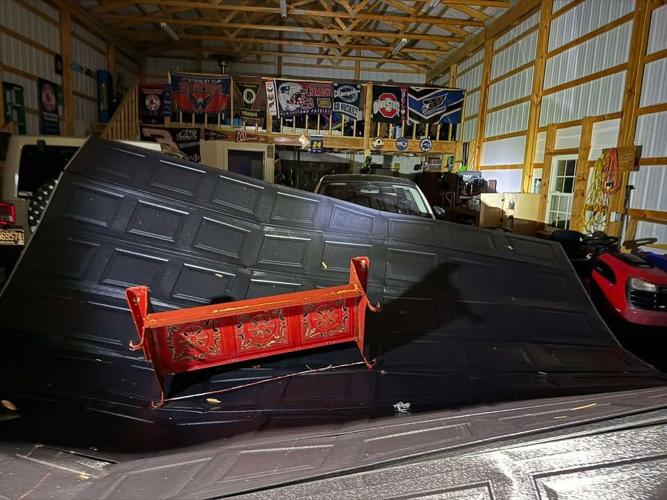 Garage door damaged by storm.