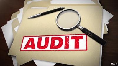 File folders stacked with papers, and a magnifying glass and pen on top, with the word "audit" stamped across a folder in red text.