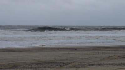 Large waves crashing at the shoreline on the beach of Ocean City, Maryland