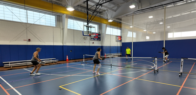 People playing on indoor pickleball courts at the Kent County Recreation Center in Dover.