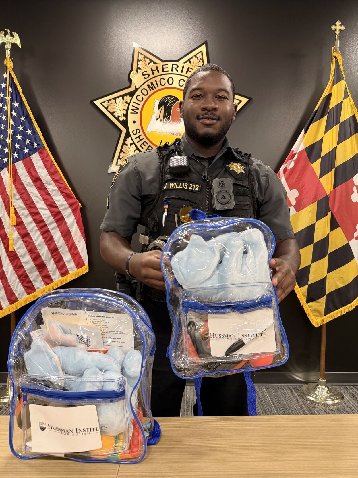 A Wicomico County Sheriff's deputy poses with the department's new Autism Support Backpacks