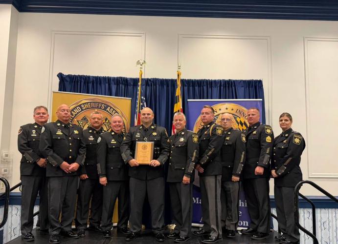 Members of the Wicomico County Sheriff's Office stand with Corporal Kevin Perretta as he accepts his award. 