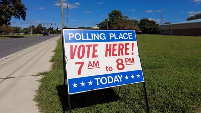 Sign reading "Polling Place VOTE HERE! 7AM to 8PM"