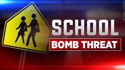 The words "school bomb threat" in front of a student crossing sign