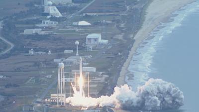 A rocket launches near a beach from Wallops Island in Accomack County, Virginia. 