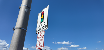 Red-light camera warning sign in Dover, Del. that reads "Photo Enforced."