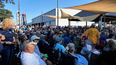 The crowd watches attentively as the 2026 Chincoteague Pony Auction gets underway on the island's carnival grounds.