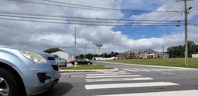 Car pulling up to a pedestrian crosswalk along Route 14 in Milford.