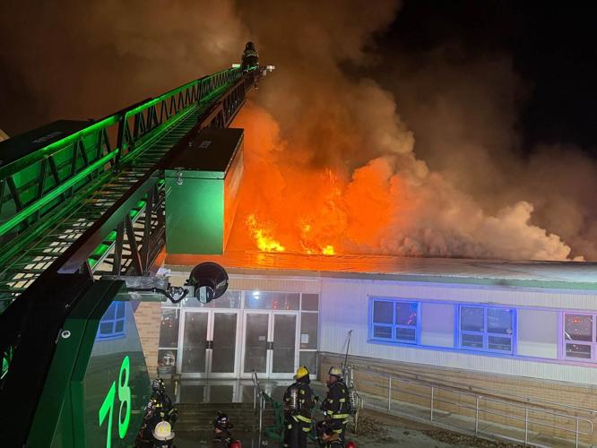 Fire ablaze atop the roof of Lulu Ross Elementary School in Milford