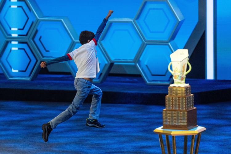 Photos of students competing for the Scripps National Spelling Bee trophy