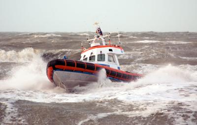 A coast guard ship on breaking waves