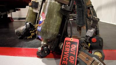 Self-Contained Breathing Apparatus on the ground of the Stockton Volunteer Fire Company. Tag attached to cylinder reading "OUT OF SERVICE". 