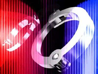 One Charged, One Sought after Drugs, Guns Found