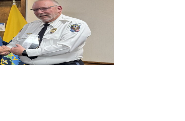 Denton Police Chief George Bacorn is presented with a 35 years of service award.