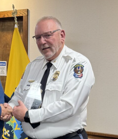 Denton Police Chief George Bacorn is presented with a 35 years of service award.