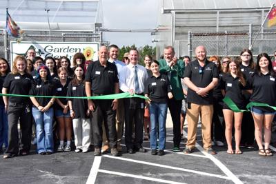The horticulture program poses for a photo in front of the new greenhouse. 