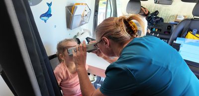 Child at Dover YMCA summer camp receiving a vision screening in a Vision to Learn mobile clinic.