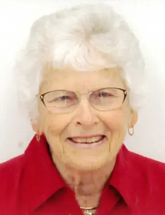 Woman with white hair, wearing glasses and red top with white background