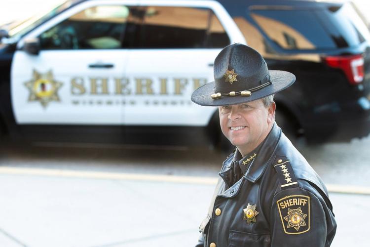 Sheriff Mike Lewis stands in front of a Wicomico County Sheriff's Office patrol car