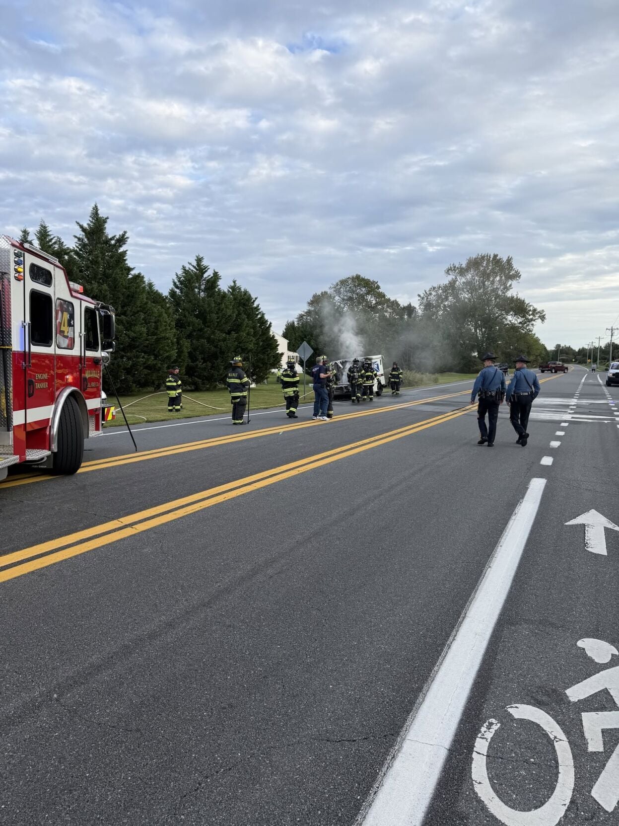 Postal truck smoking with firefighters around