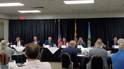 Julie Giordano, along with the delegation sitting in front of a crowd of people. 