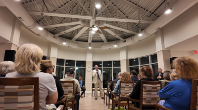 Andy Harris speaks to the audience during a candidate forum in Cambridge.