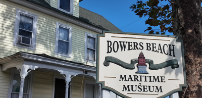 Bowers Beach Maritime Museum sign in front of original museum building.