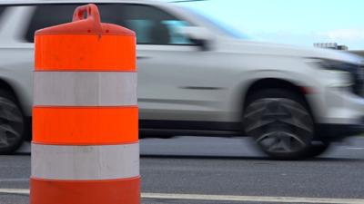 Car going past construction