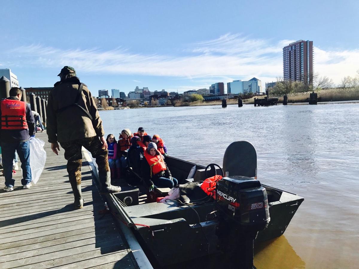 VIDEO Hundreds get together to clean the Christina River, one piece of