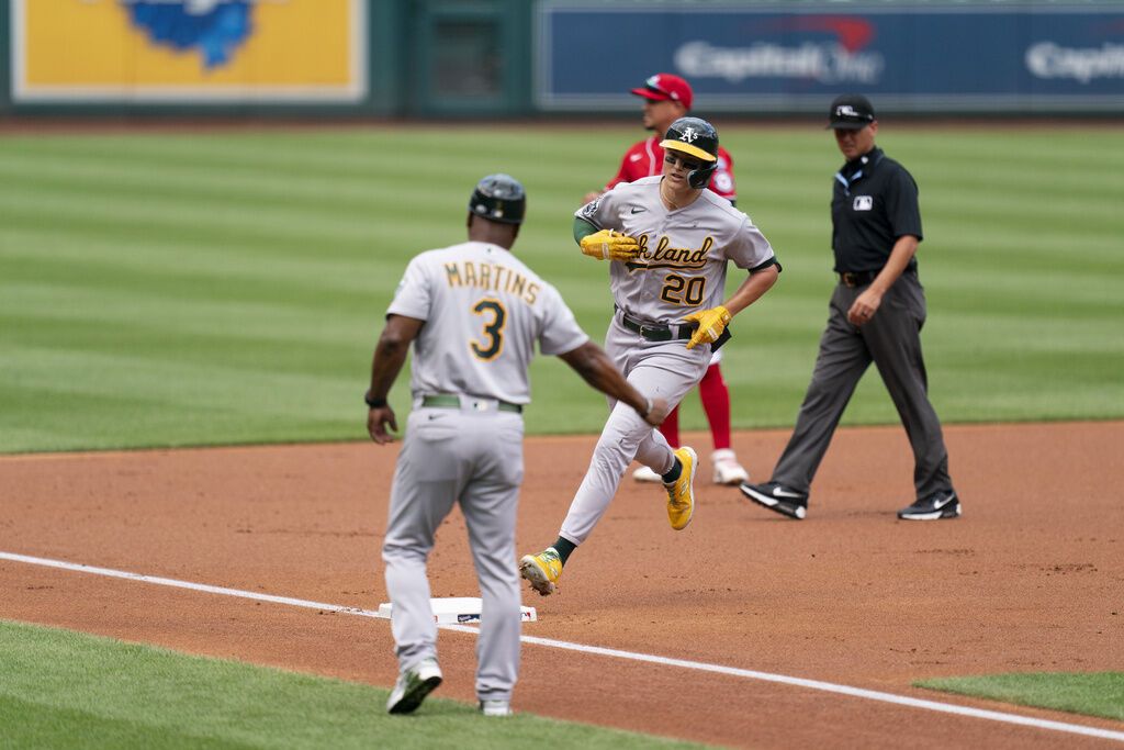 Oakland A?s rookie Mark McGwire, left, watches his third home run