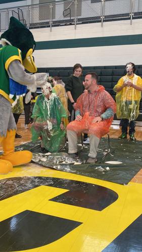 Katy Hoffecker is hit by a pie during Pi Day 2022