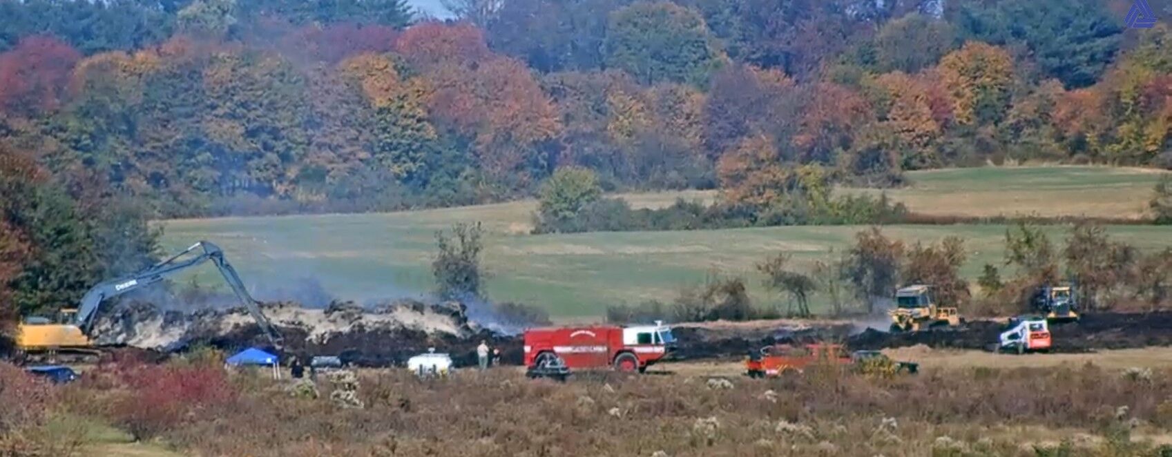 Crews burning off smoldering hay bales