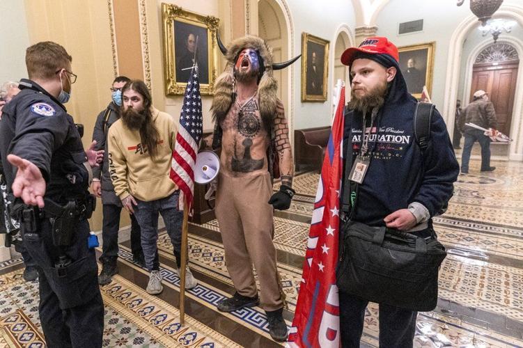 Supporters of President Donald Trump are confronted by Capitol Police officers outside the Senate Chamber