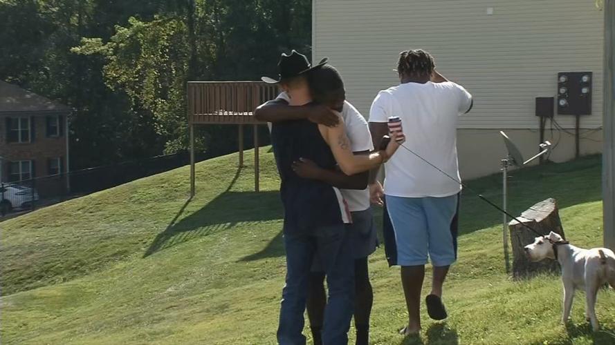 Richard Watts hugs murder victim's brother