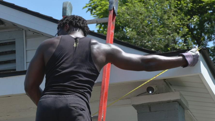 University of Louisville football players help repair a home in the Portland neighborhood