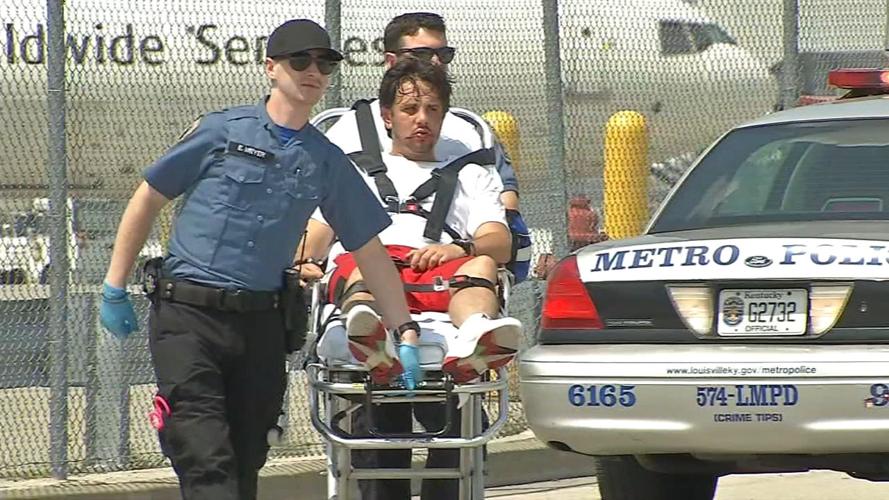 Brandon Hinton (suspect accused of stealing LMPD vehicle, on stretcher)