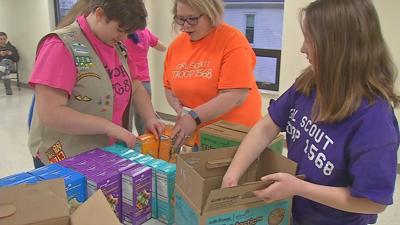 Girl Scouts packing cookies