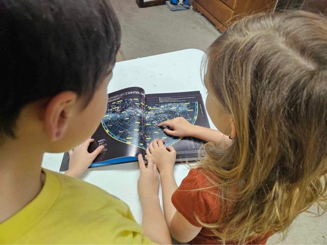 Children look at star display map.JPG