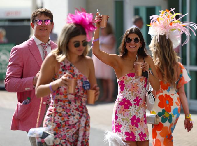 Woman raises glass at Oaks.JPG