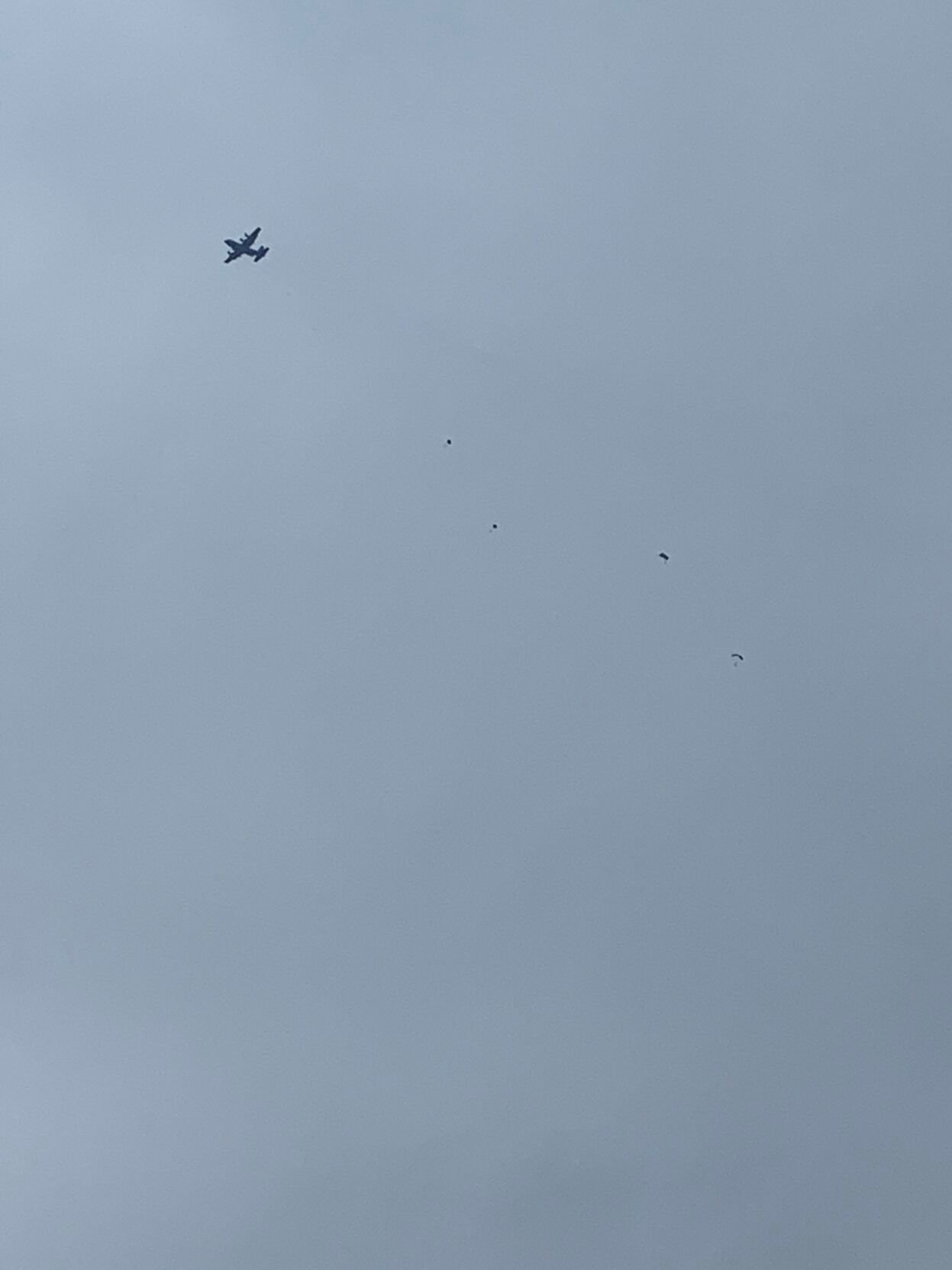 Paratroopers descend from the sky after jumping out of a plane during the 2021 Thunder Over Louisville air show
