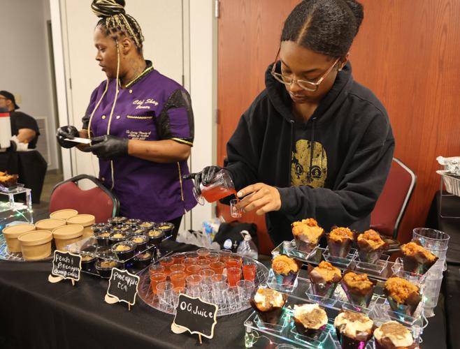 Vendors pour drinks at Taste of West Louisville.JPG