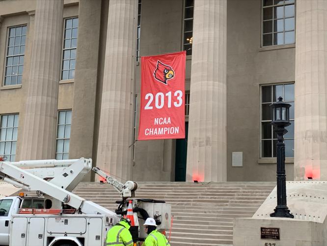 Banner hung at Louisville's Metro Hall to honor 2013 U of L men's basketball team as NCAA Champs