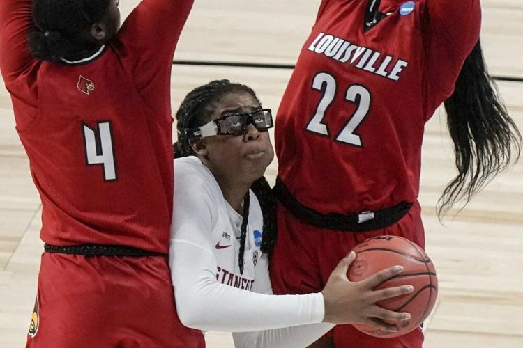 Stanford's Francesca Belibi looks to shoot between Louisville's Elizabeth Balogun and Elizabeth Dixon