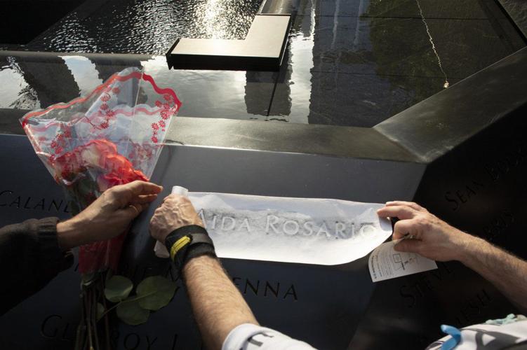9-11 ceremony - Louis Gonzalez makes a rubbing of his sister's name at the National September 11 Memorial.jpeg