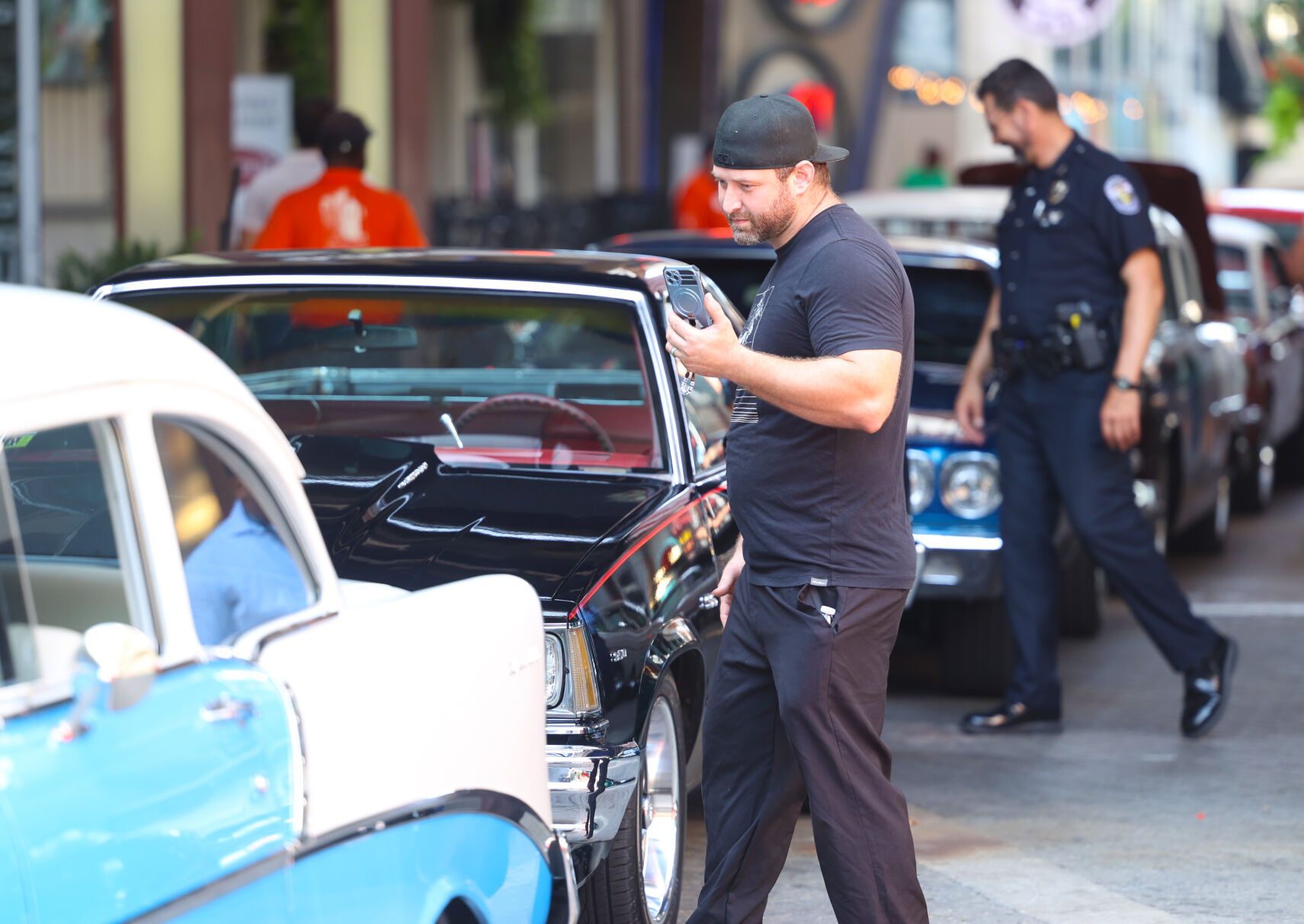 Man takes video of Street Rods.JPG